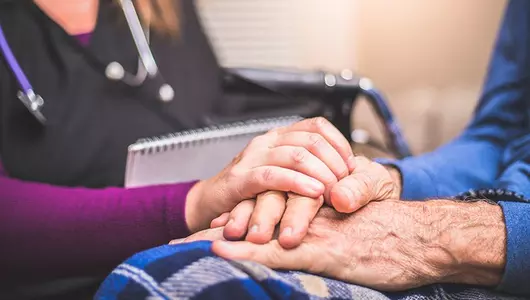 provider holding patient's hand