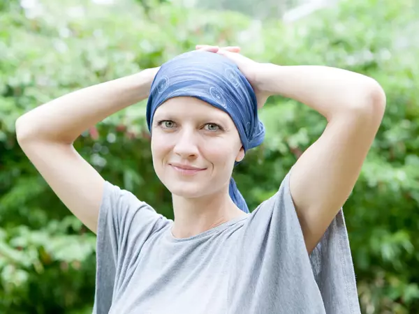 Foundation Gifts Cancer Patients Head Coverings I Gundersen   Young Woman With Cancer Smiling With Head Wrap .webp