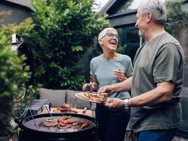 Senior couple preparing barbecue