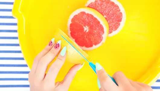 woman slicing orange