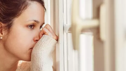 woman staring out the window