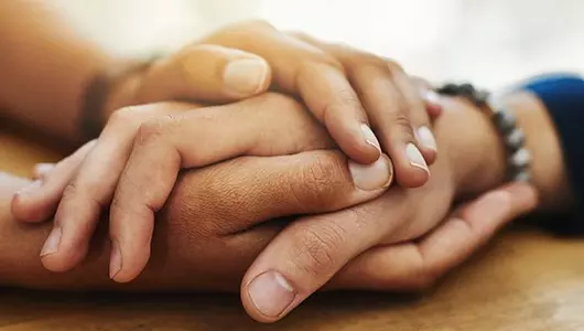 person holding the hand of another in both hands