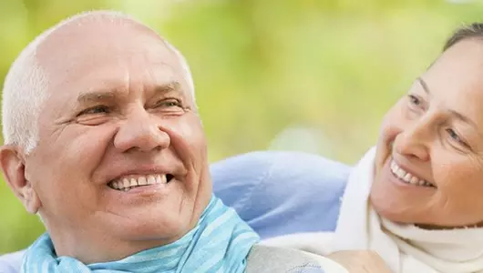 Older couple smiling outdoors