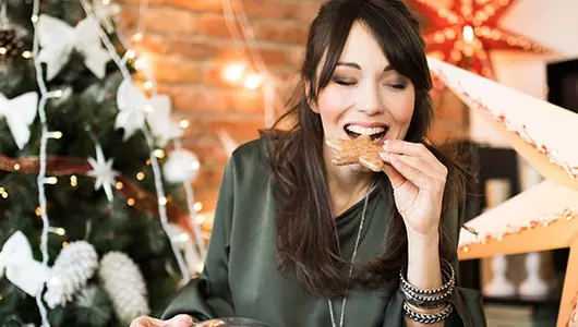 woman eating Christmas cookie