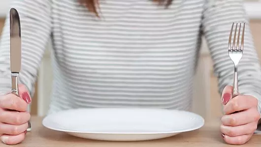 What is intermittent fasting-woman with dinner plate