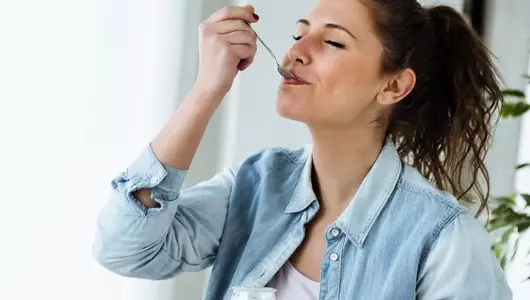 woman eating yogurt