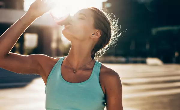 woman drinking a bottle of water