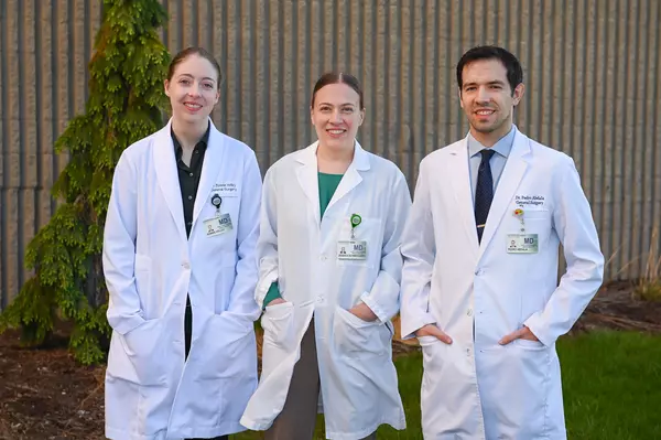 Three chief surgery residents from Gundersen pictured in white lab coats.